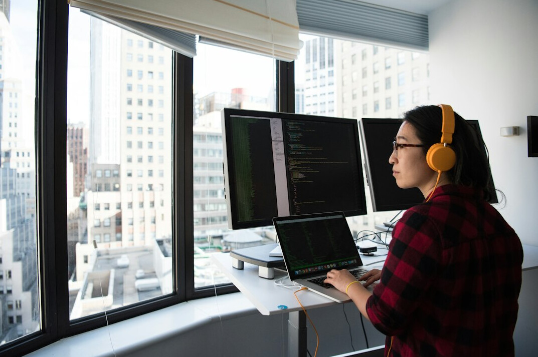Team reviewing digital insurance dashboards on a laptop in a modern office